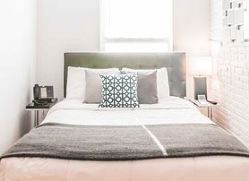 Bed with bronze colored pillows