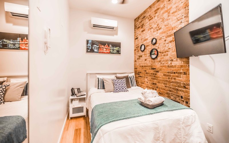 king room with large bed and purple pillows