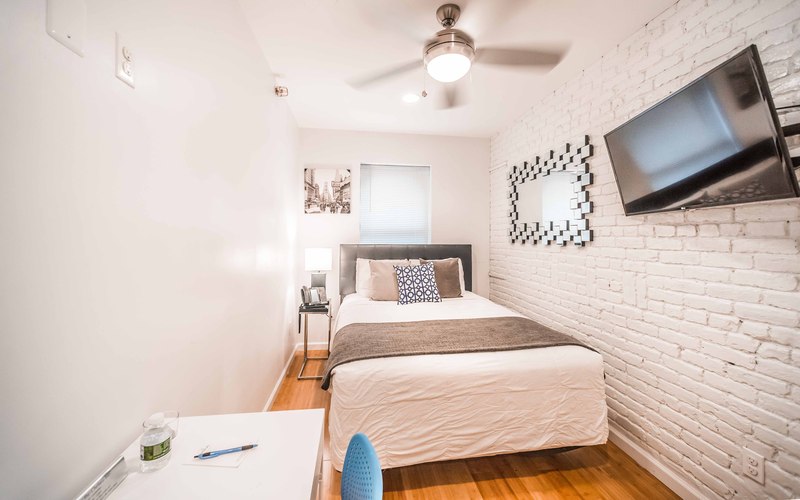 king room with large bed and purple pillows