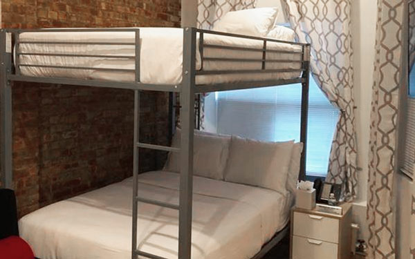 king room with large bed and purple pillows